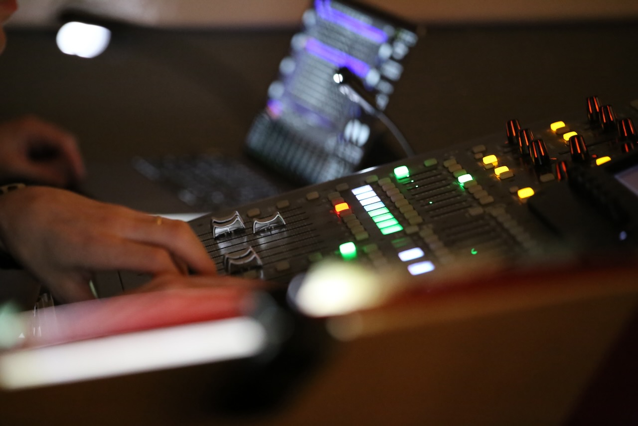 A close up of a sound desk and laptop
