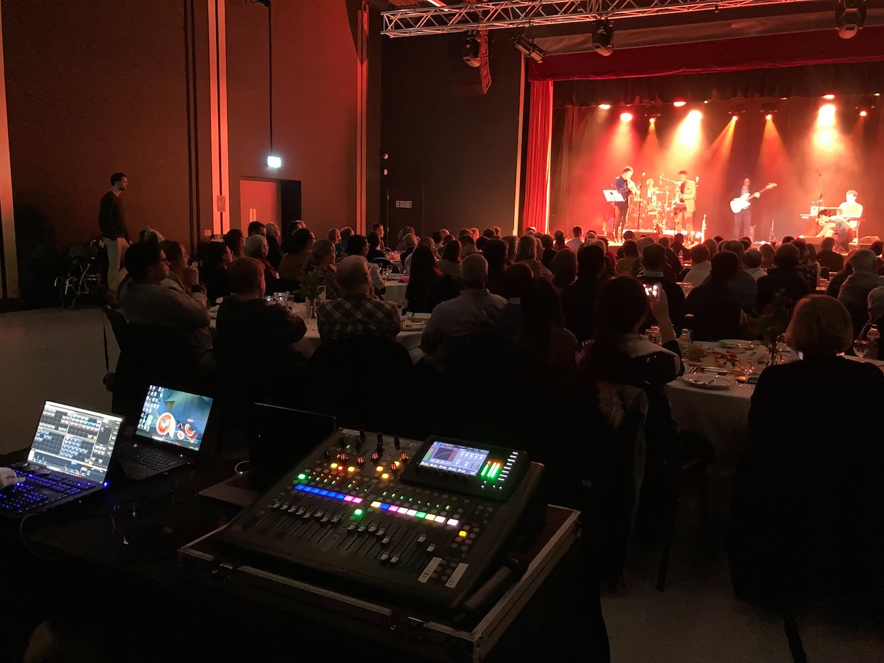 Technical control position overlooking a Roots of Jazz event around tables