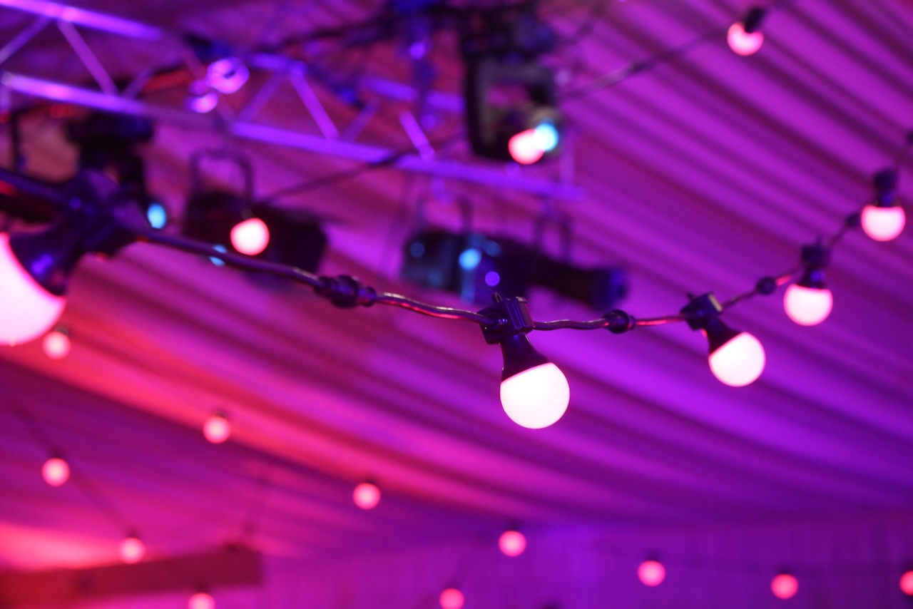 A close up of pink and purple festoon lights